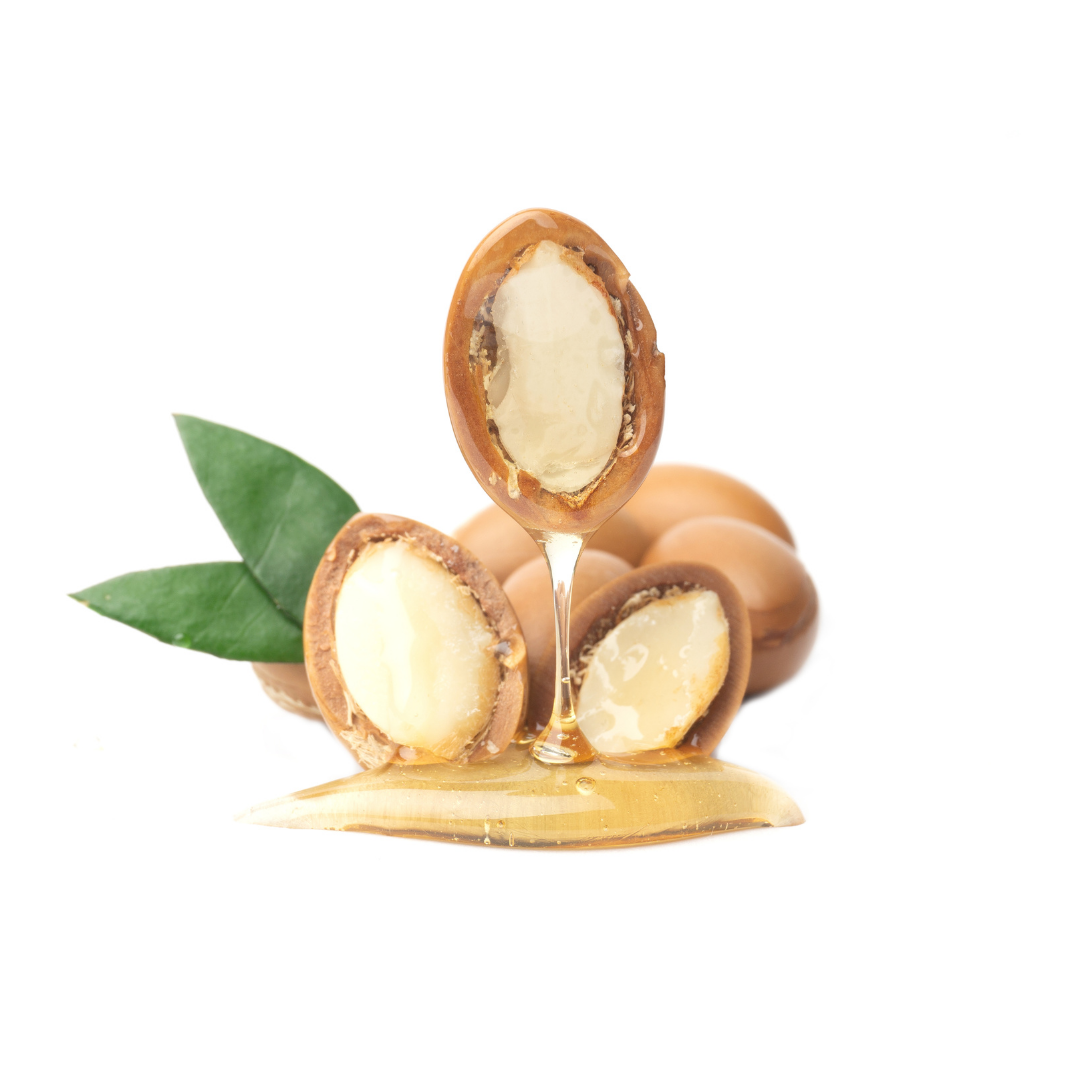 Cracked argan nuts with oil dripping from the kernels