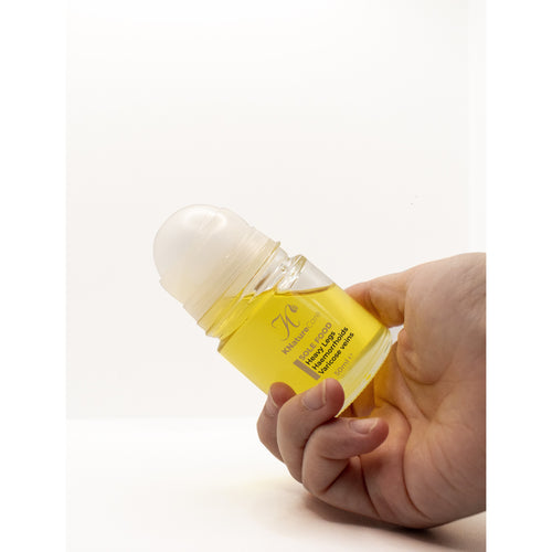 Hand holding the Sole Food roll-on bottle from the Head to Toe Bundle